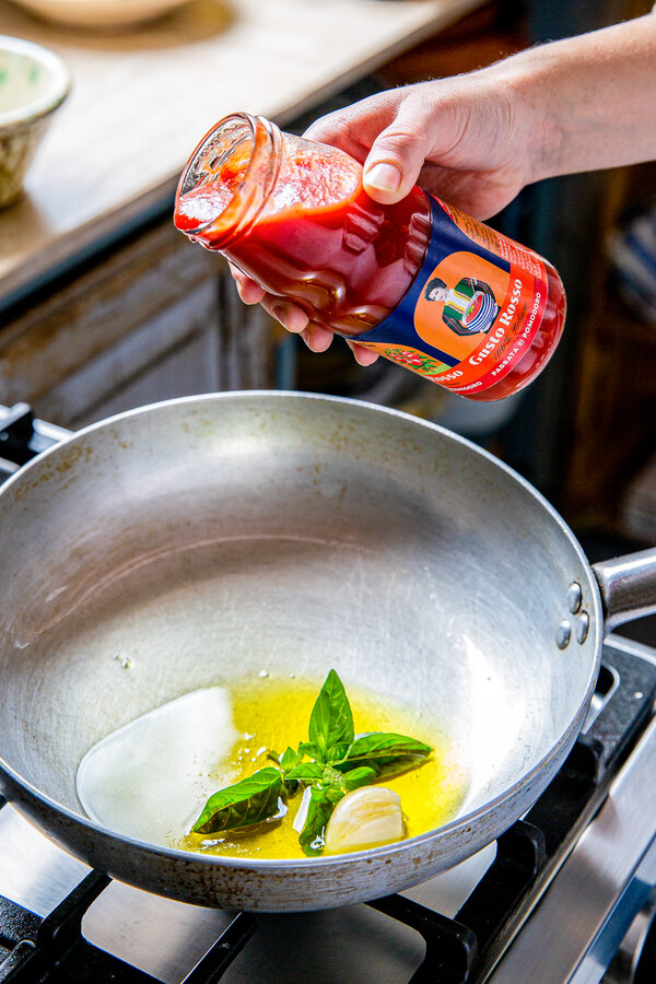 Add the olive oil, garlic and passata to the pan